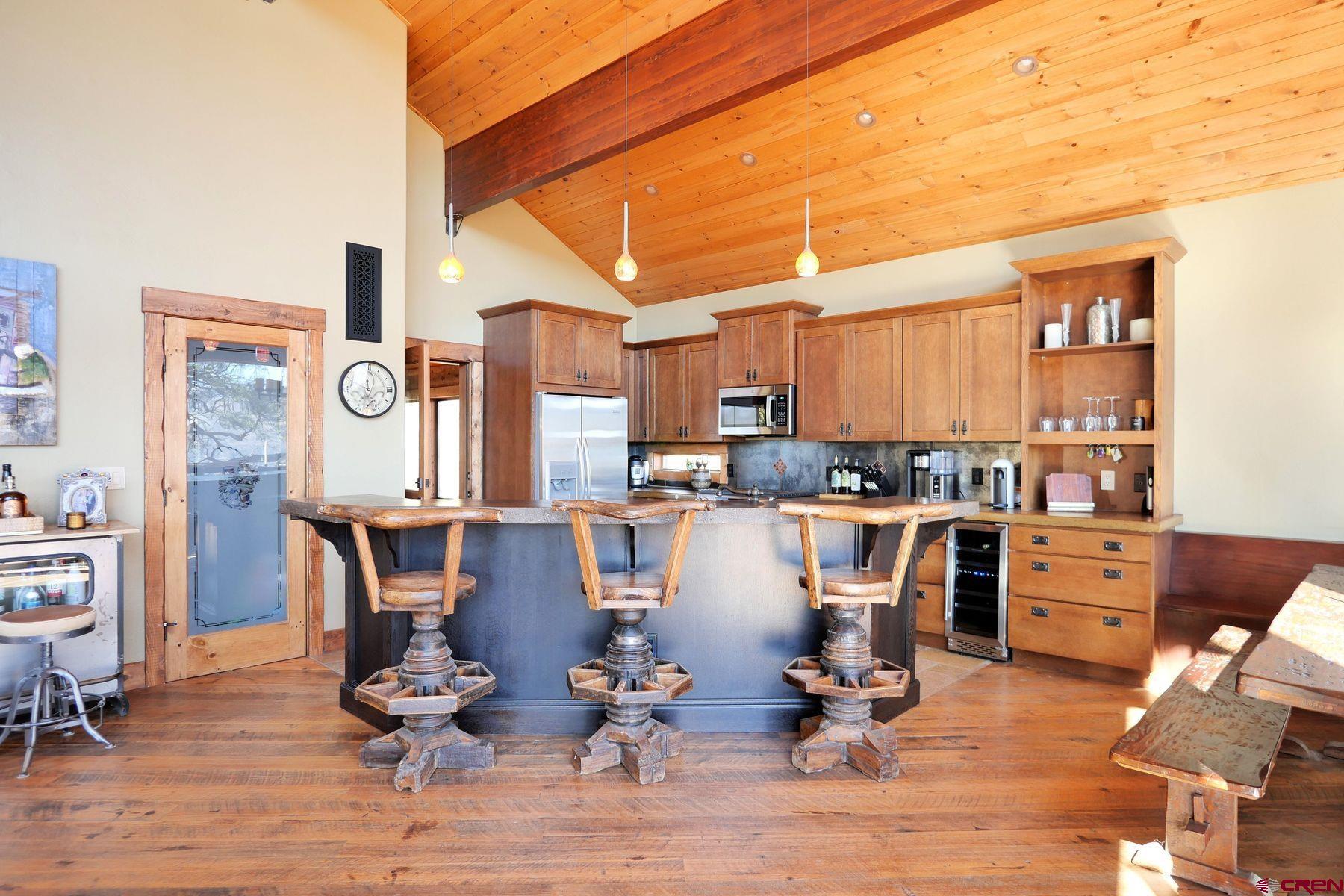 178 Valley View Road Ridgway, CO 81432 - Photo 6 of 45 a room with stainless steel appliances a dining table wooden floor and view kitchen