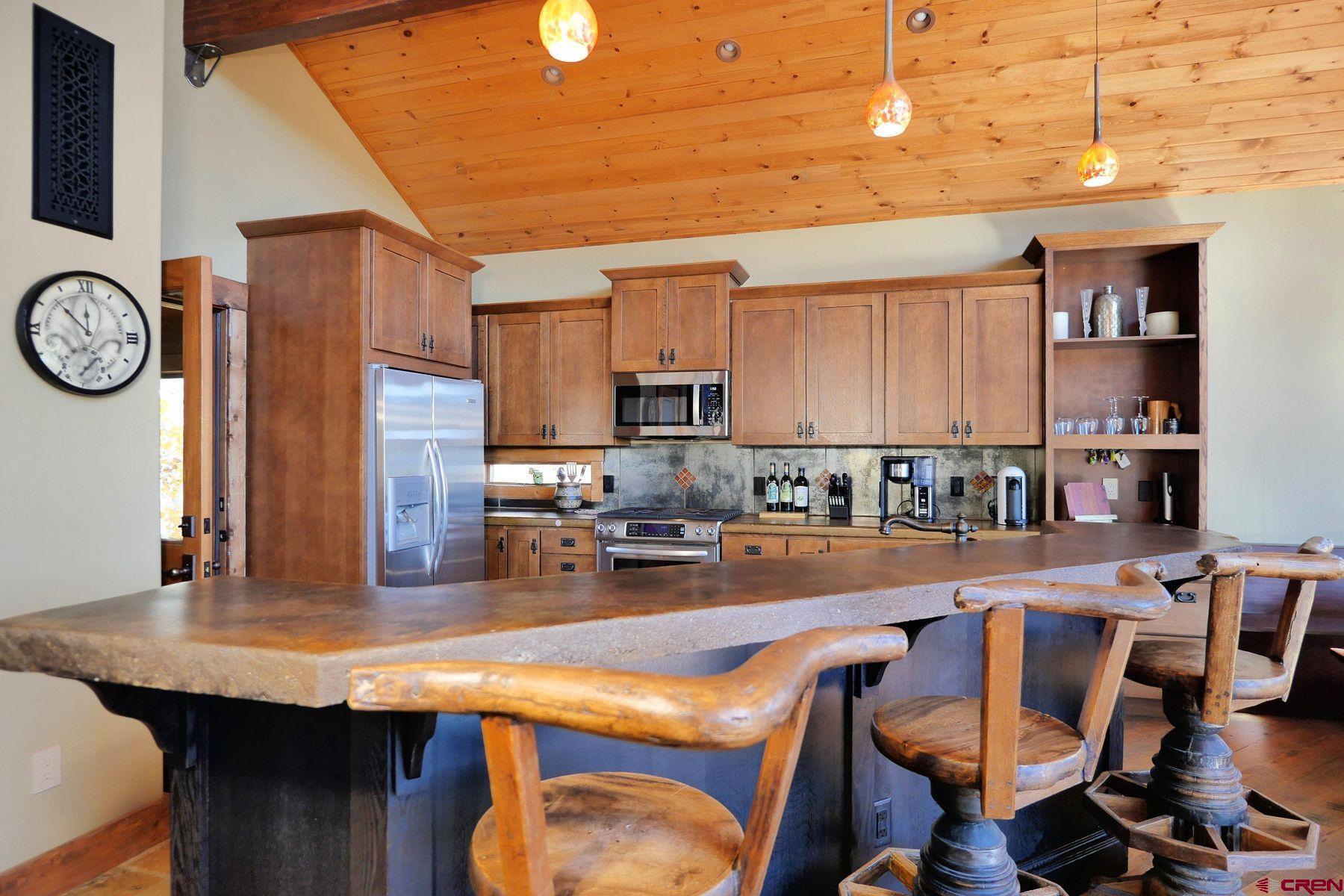 178 Valley View Road Ridgway, CO 81432 - Photo 7 of 45 a kitchen with a table chairs and a refrigerator