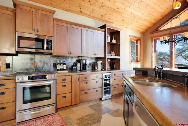 a kitchen with stainless steel appliances granite countertop a stove sink and cabinets