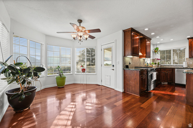 4117 North Wolf Ridge Circle Eden, UT 84310 - Photo 7 of 63 Bay window dining area featuring wood-finish flooring, a ceiling fan with integrated lighting, and direct access to the kitchen