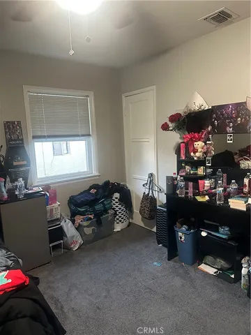 a bedroom with furniture and a window