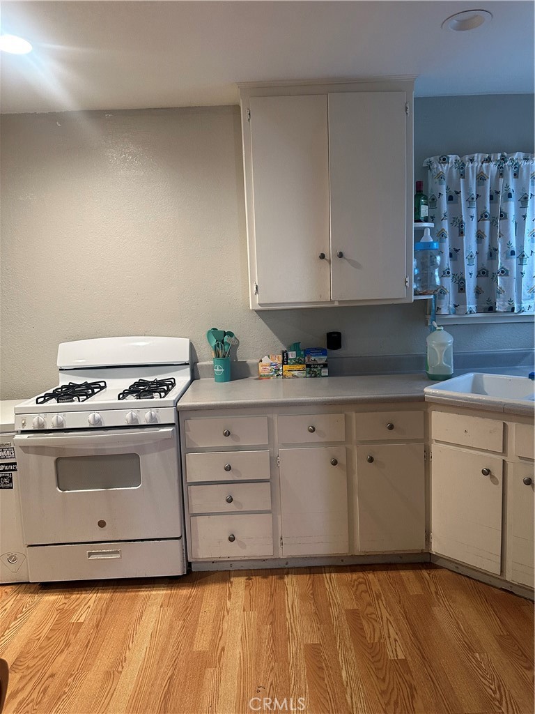 404 Sievers Avenue Brea, CA 92821 - Photo 8 of 21 a kitchen with granite countertop white cabinets and white appliances