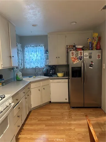 a kitchen with cabinets and white appliances