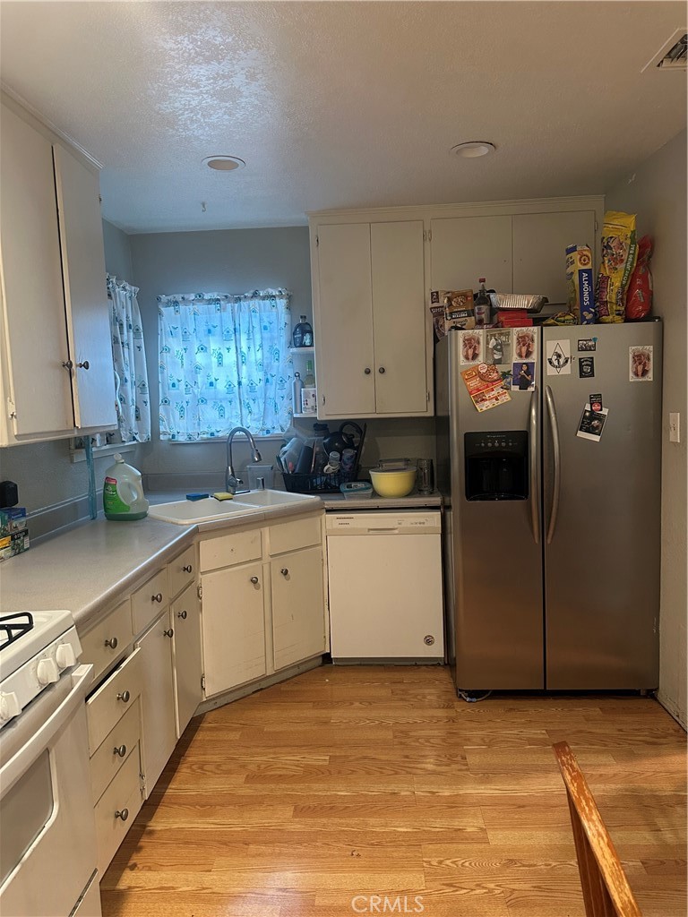 404 Sievers Avenue Brea, CA 92821 - Photo 9 of 21 a kitchen with cabinets and white appliances