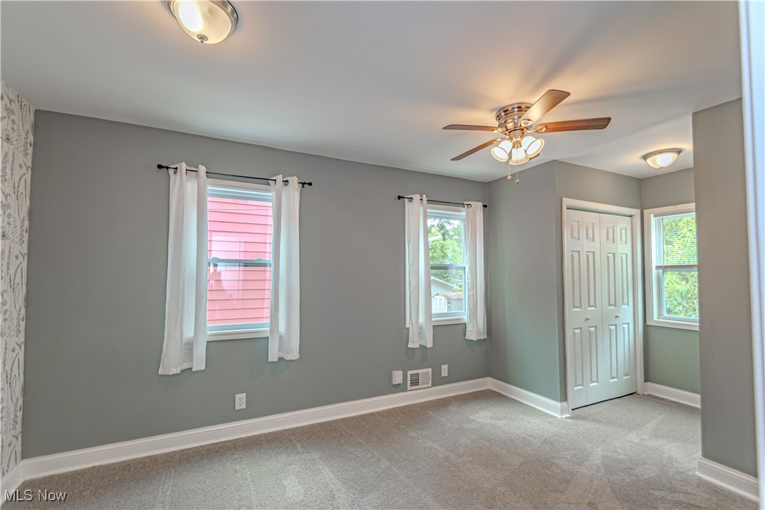 360 Baldwin Road Akron, OH 44312 - Photo 11 of 22 Unfurnished bedroom featuring carpet floors, multiple windows, and a closet