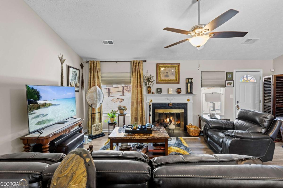 6324 Amberly Road Rex, GA 30273 - Photo 10 of 22 a living room with furniture fireplace and a flat screen tv