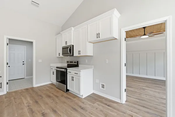 a view of an empty room with wooden floor