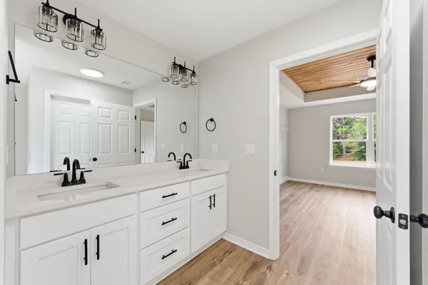 a bathroom with a granite countertop shower and a toilet