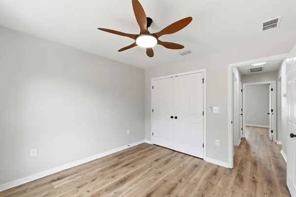 a close view of a sink a light fixture and a bathroom