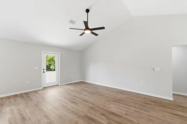 a view of a kitchen with wooden floor and a kitchen