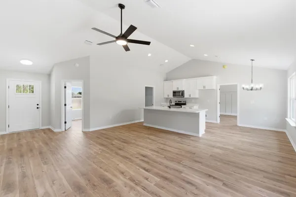 a kitchen with white cabinets and appliances
