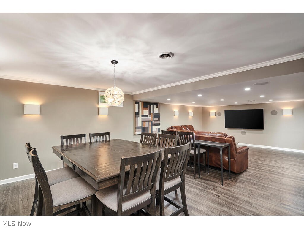 5172 Shillings Way Akron, OH 44321 - Photo 20 of 26 Dining space with hardwood / wood-style flooring and crown molding