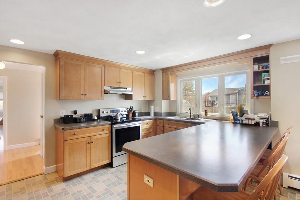 3 Jade Street Methuen, MA 01844 - Photo 13 of 35 a kitchen with sink a stove and cabinets
