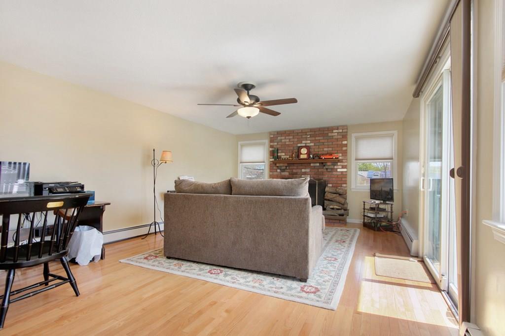 3 Jade Street Methuen, MA 01844 - Photo 17 of 35 a living room with furniture a dining table and a fireplace