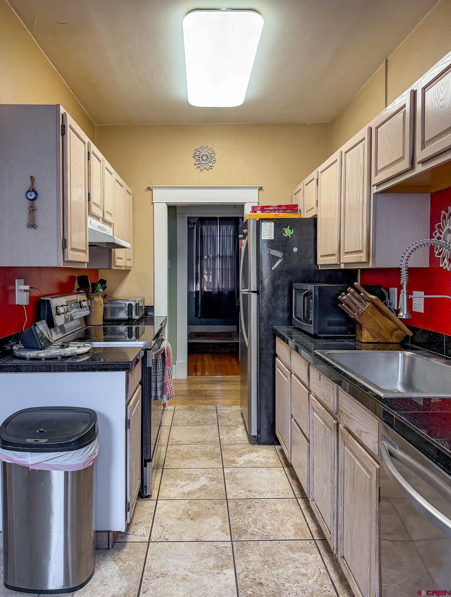8903 Marshalls Road Austin, CO 81410 - Photo 20 of 45 a kitchen with stainless steel appliances granite countertop a stove and a sink