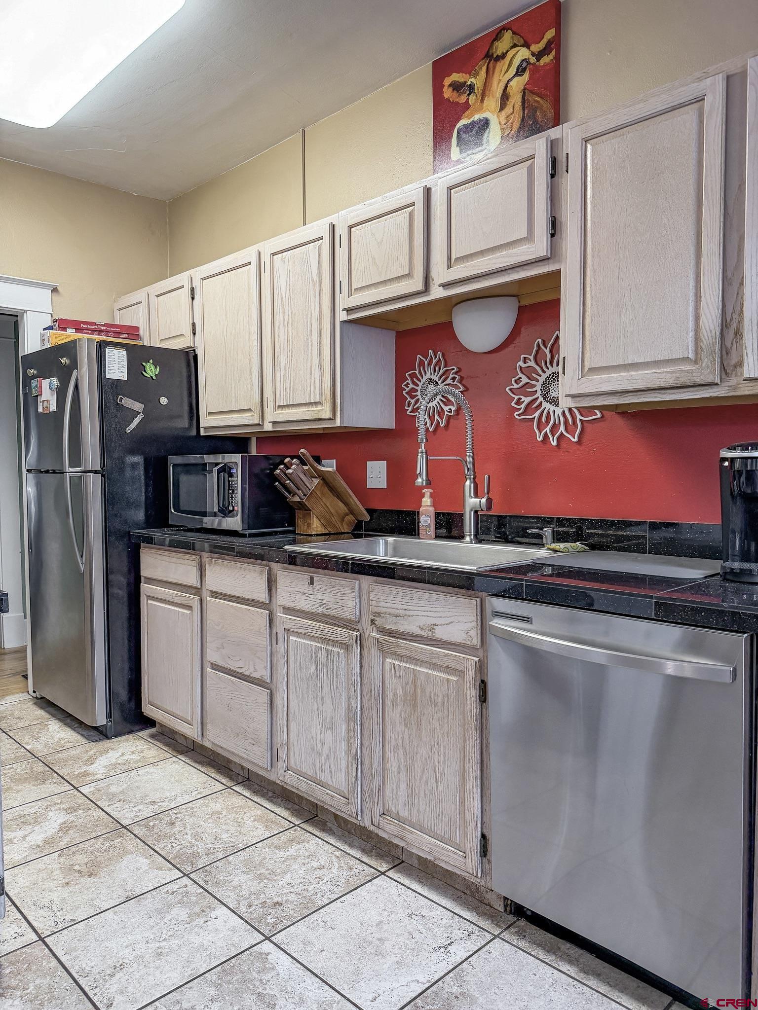 8903 Marshalls Road Austin, CO 81410 - Photo 22 of 45 a kitchen with stainless steel appliances granite countertop a sink and cabinets