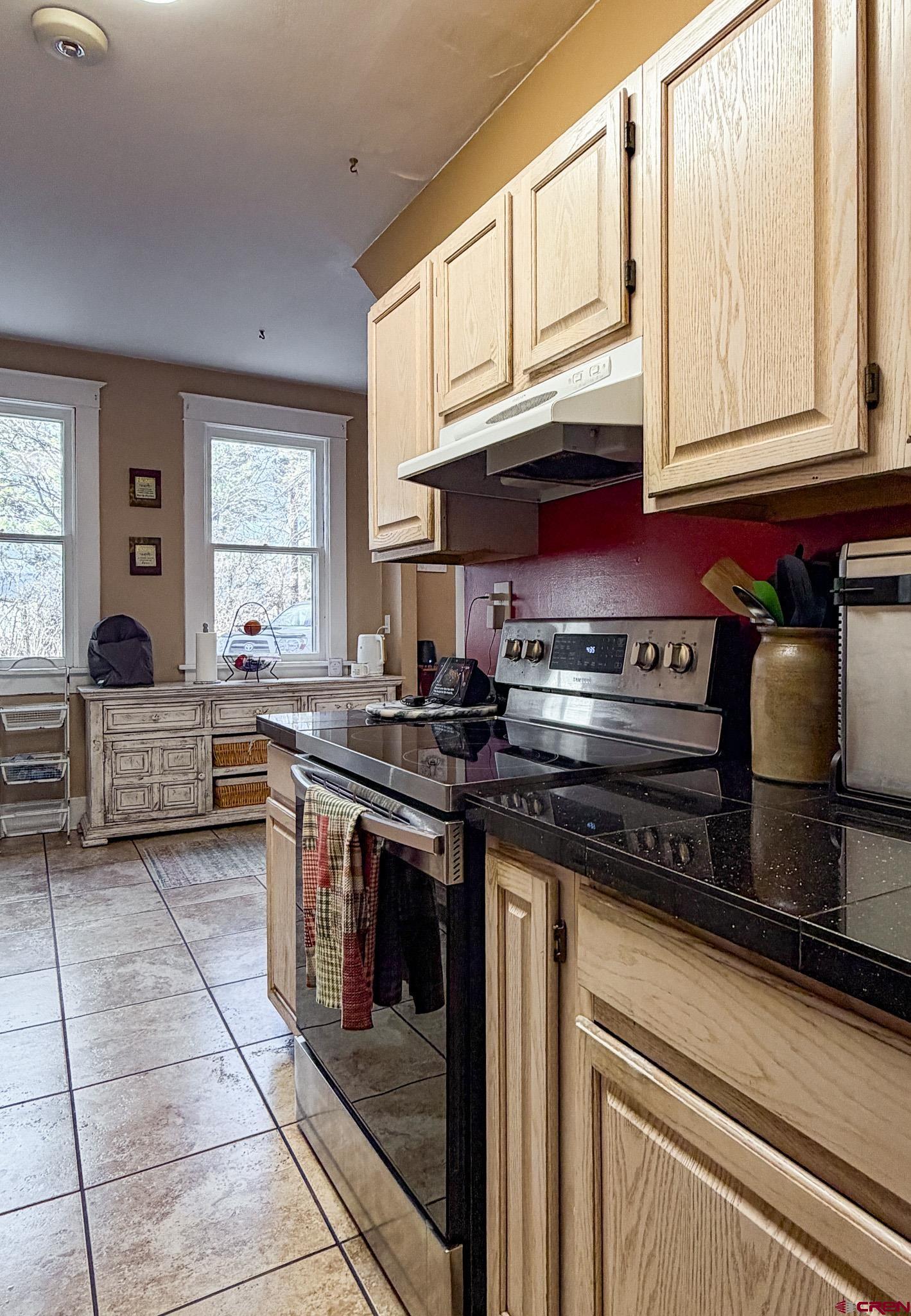 8903 Marshalls Road Austin, CO 81410 - Photo 23 of 45 a kitchen with stainless steel appliances granite countertop a stove and a sink