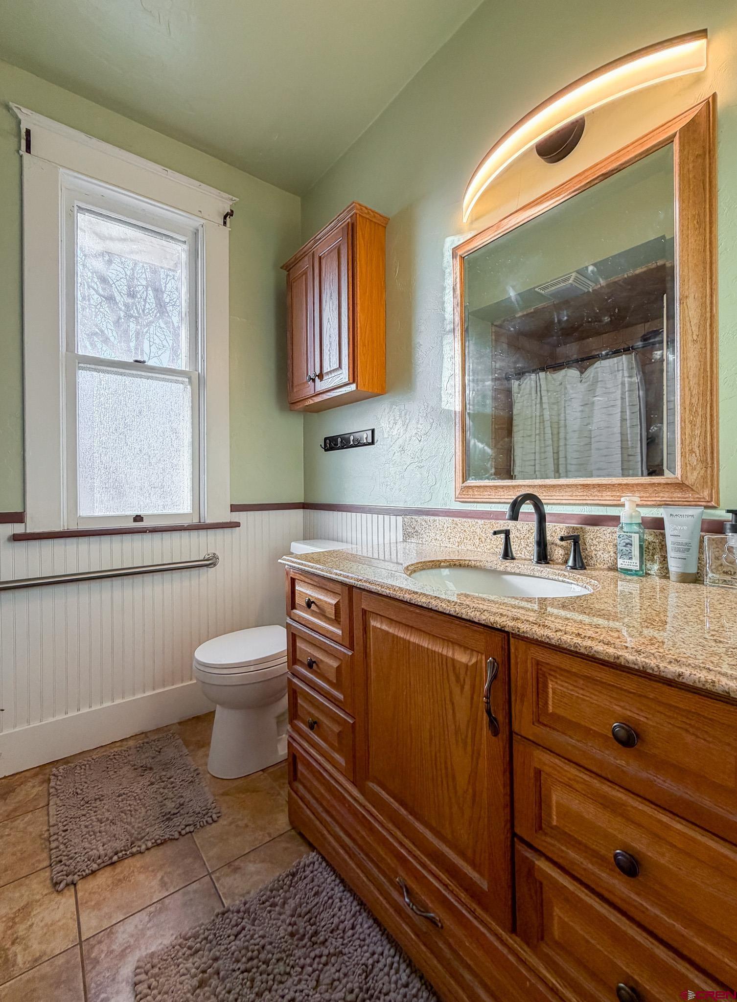 8903 Marshalls Road Austin, CO 81410 - Photo 25 of 45 a bathroom with a toilet sink and mirror