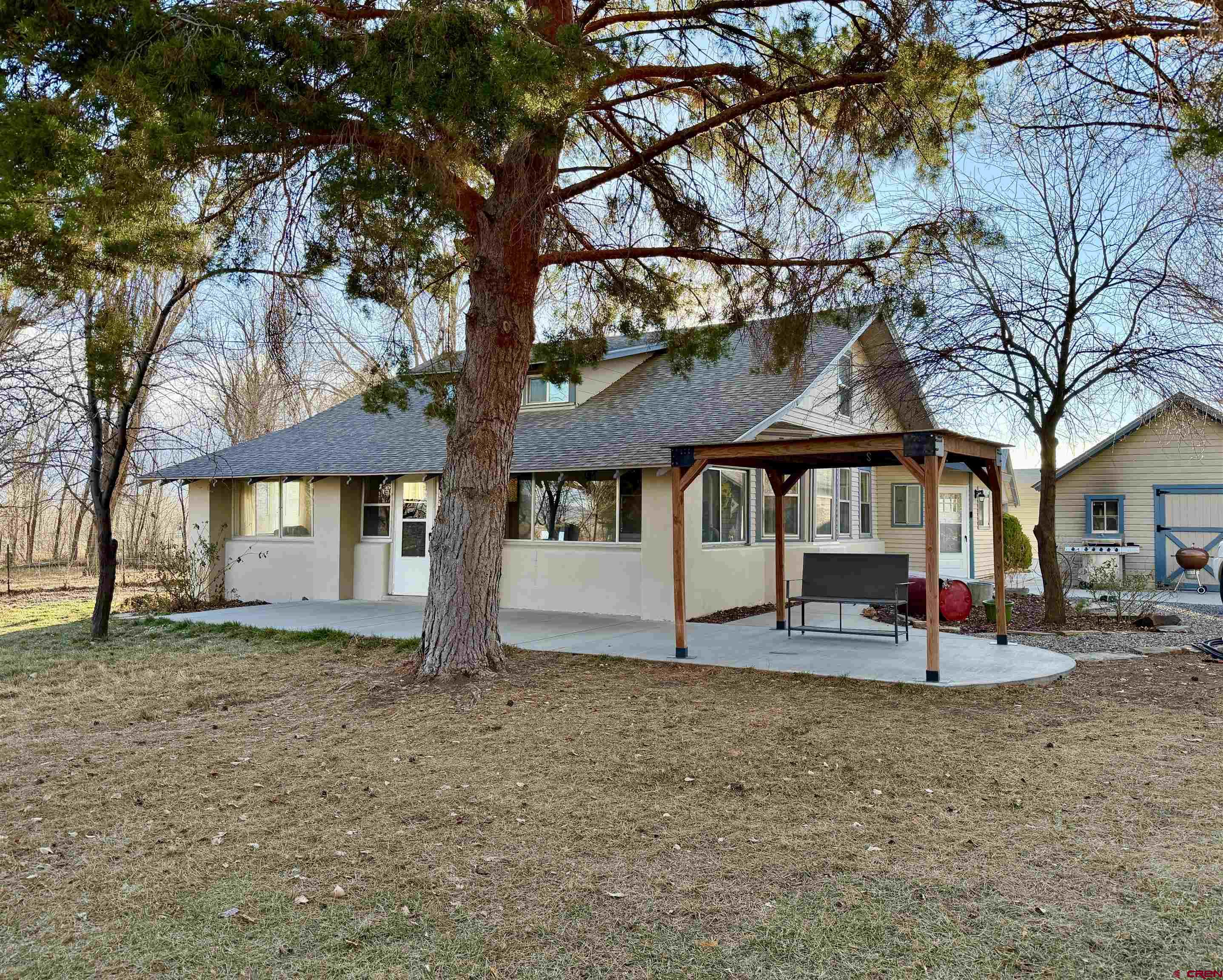 8903 Marshalls Road Austin, CO 81410 - Photo 34 of 45 a front view of a house with a yard tree and wooden fence