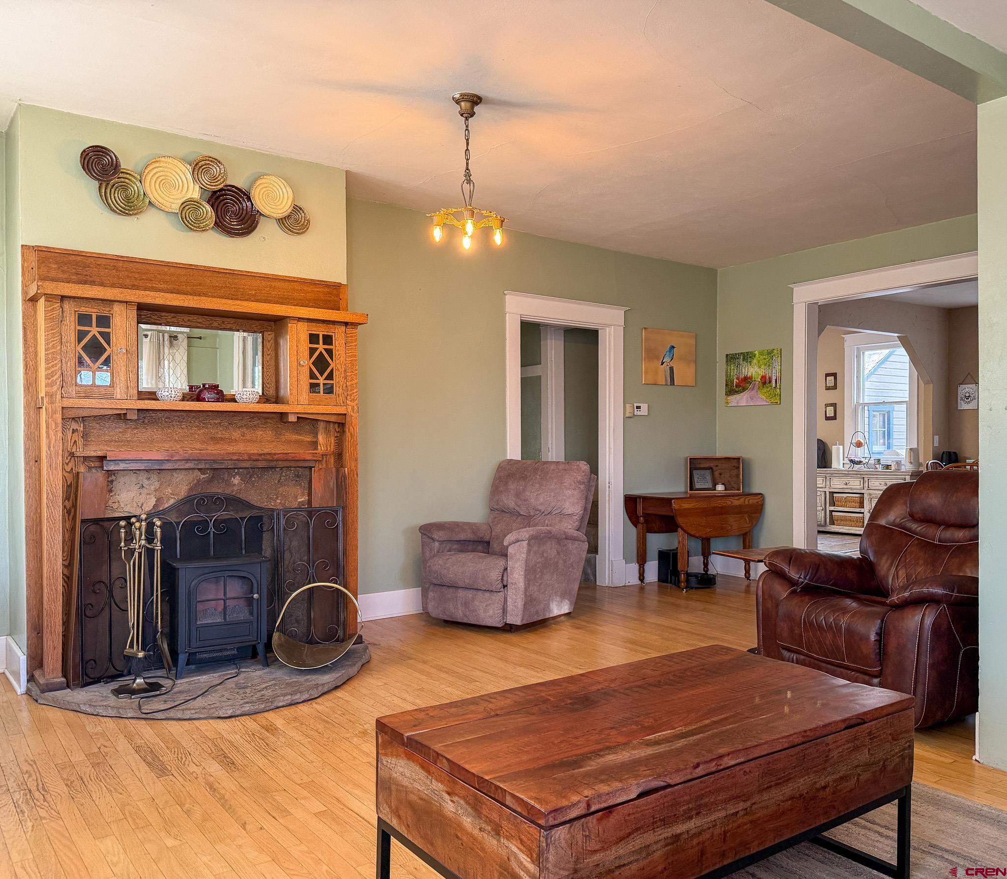 8903 Marshalls Road Austin, CO 81410 - Photo 44 of 45 a living room with furniture a fireplace and a chandelier