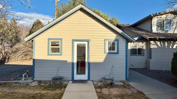 a view of house with a yard