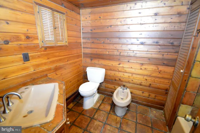 a bathroom with a toilet and a sink