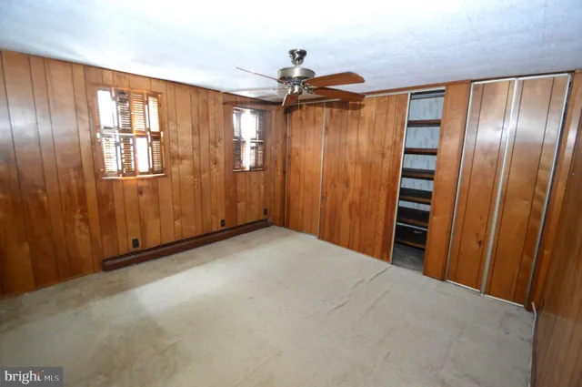 a view of a hallway with wooden shelves