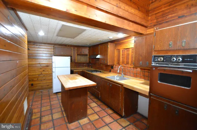 a kitchen with stainless steel appliances granite countertop a sink counter space and cabinets