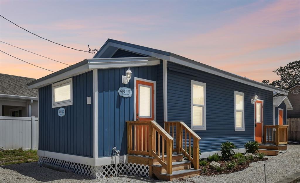 602 Skinner Boulevard Dunedin, FL 34698 - Photo 1 of 27 a front view of a house with garage