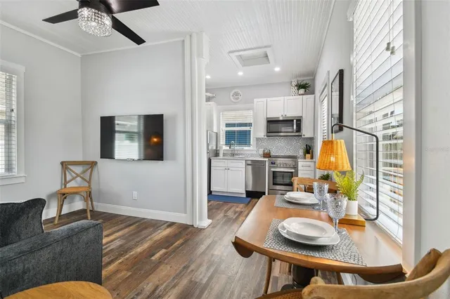 a living room with furniture and kitchen view