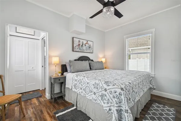 a bedroom with a bed and wooden floor