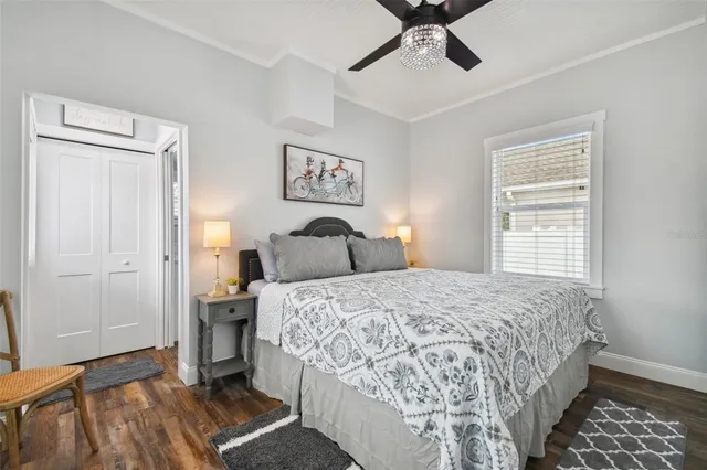 a bedroom with a bed and wooden floor