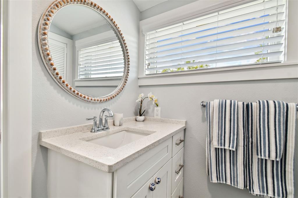 602 Skinner Boulevard Dunedin, FL 34698 - Photo 20 of 27 a bathroom with a sink and a mirror