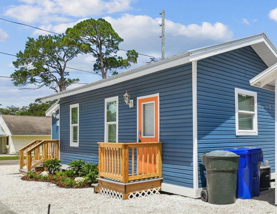 602 Skinner Boulevard Dunedin, FL 34698 - Photo 24 of 27 a front view of a house with a garden