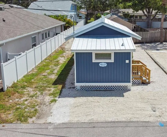 a view of a house with a wooden fence