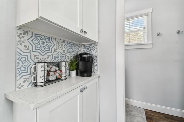 a kitchen with a sink and a fireplace with wooden floor