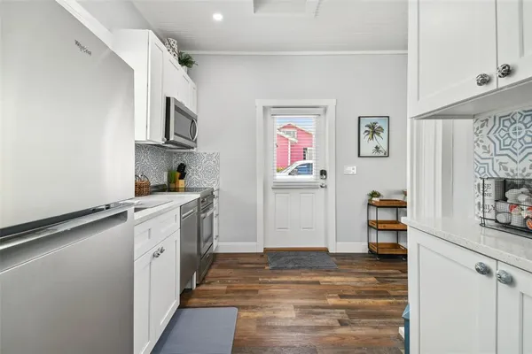 a kitchen with stainless steel appliances granite countertop a stove and a refrigerator