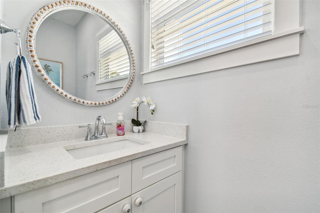 602 Skinner Boulevard Dunedin, FL 34698 - Photo 8 of 27 a bathroom with a sink and a mirror