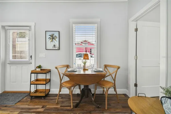 a dining room with furniture and wooden floor