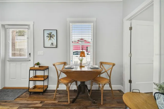 a dining room with furniture and wooden floor