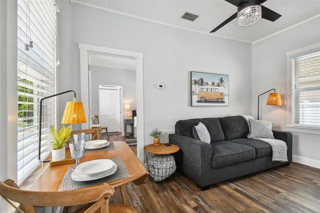 a living room with furniture and wooden floor