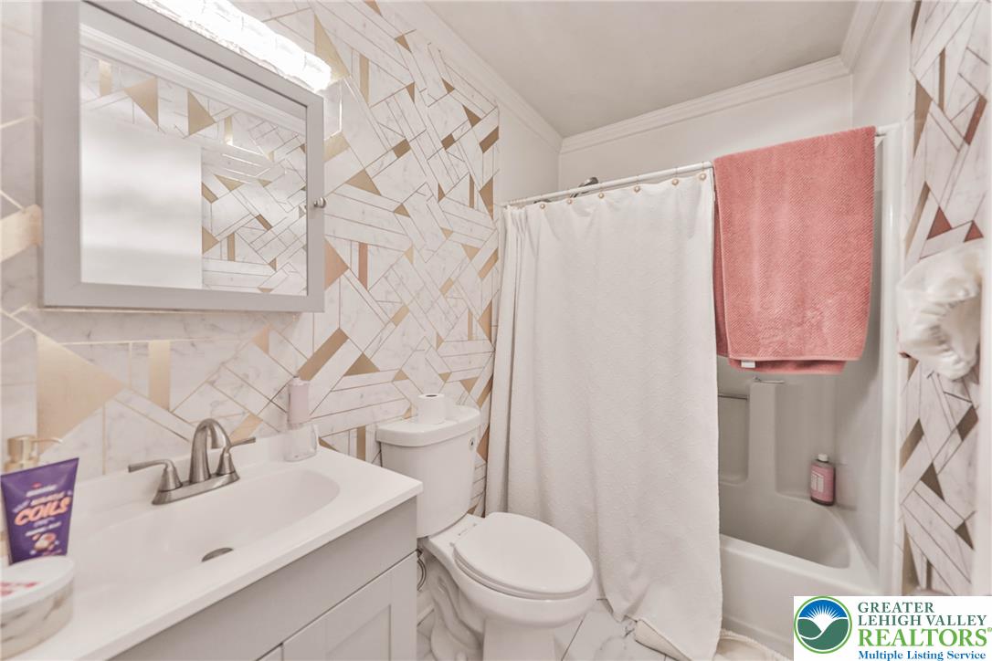 2114 Lakeview Road Bushkill, PA 18324 - Photo 41 of 83 Graphic geometric wall patterns elevate this functional bathroom space.
