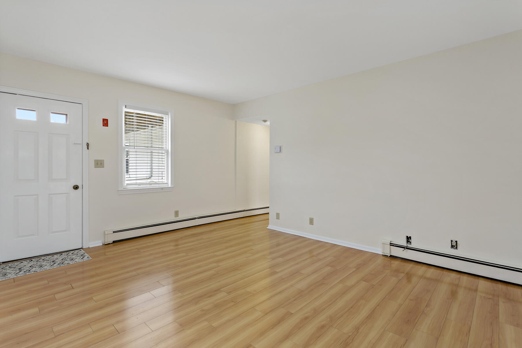 6 Wallace Avenue Buzzards Bay, MA 02532 - Photo 9 of 31 an empty room with wooden floor and windows