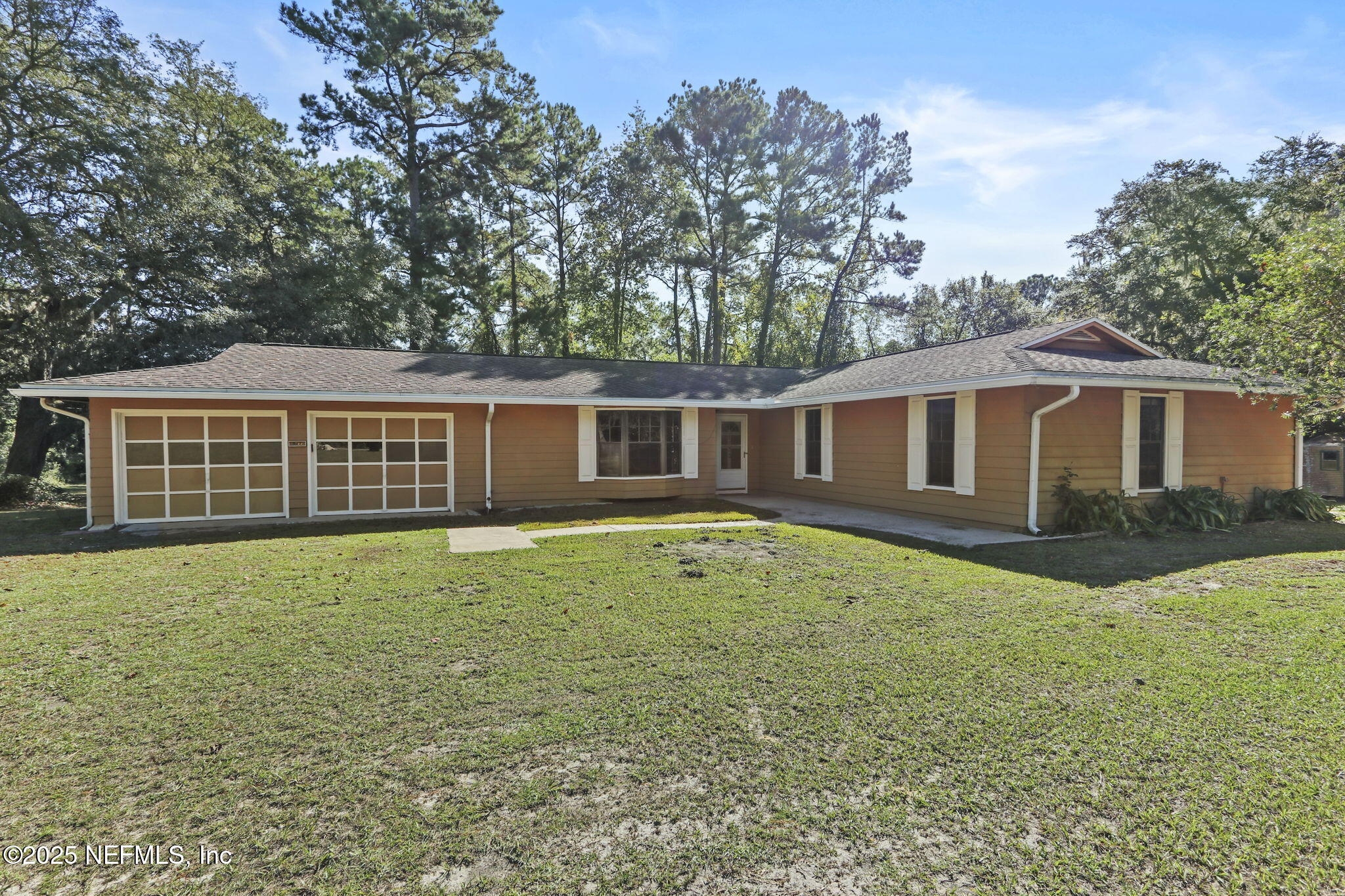 1733 Hereford Road Middleburg, FL 32068 - Photo 16 of 44 a backyard of a house with large trees and barbeque oven