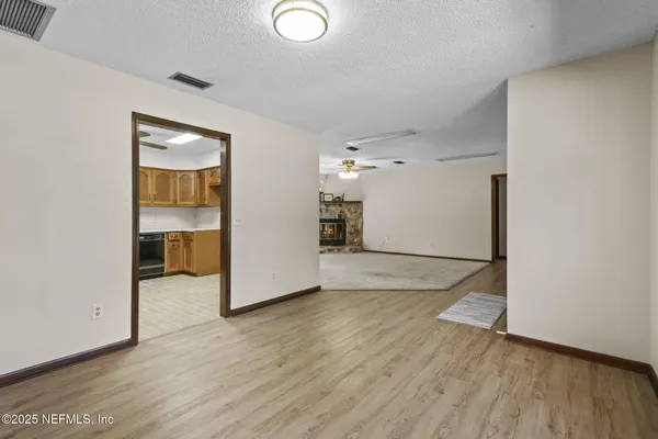 an empty room with wooden floor and a window