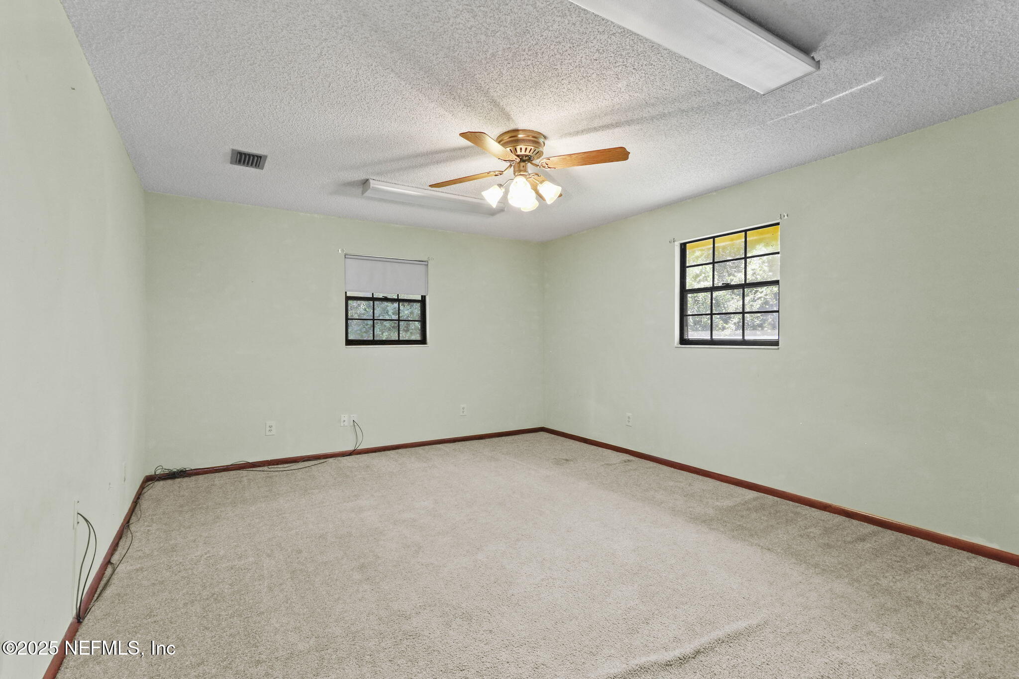 1733 Hereford Road Middleburg, FL 32068 - Photo 32 of 44 an empty room with windows and fan