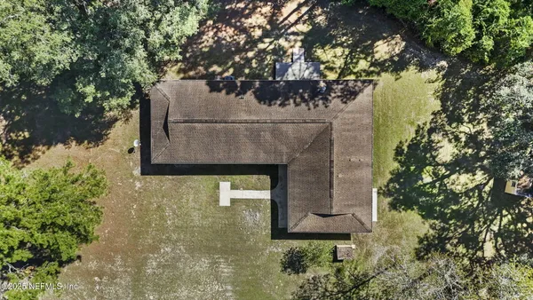a aerial view of a house with a yard
