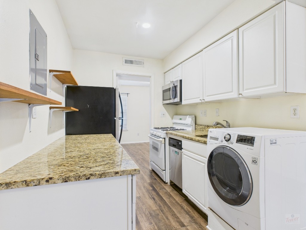 1106 West 22nd Street, Unit 5 Austin, TX 78705 - Photo 5 of 15 a kitchen with stainless steel appliances granite countertop a refrigerator sink stove and oven