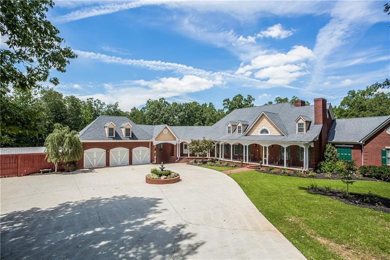 Circular driveway and Massive rocking chair front porch overlooks manicured private grounds
