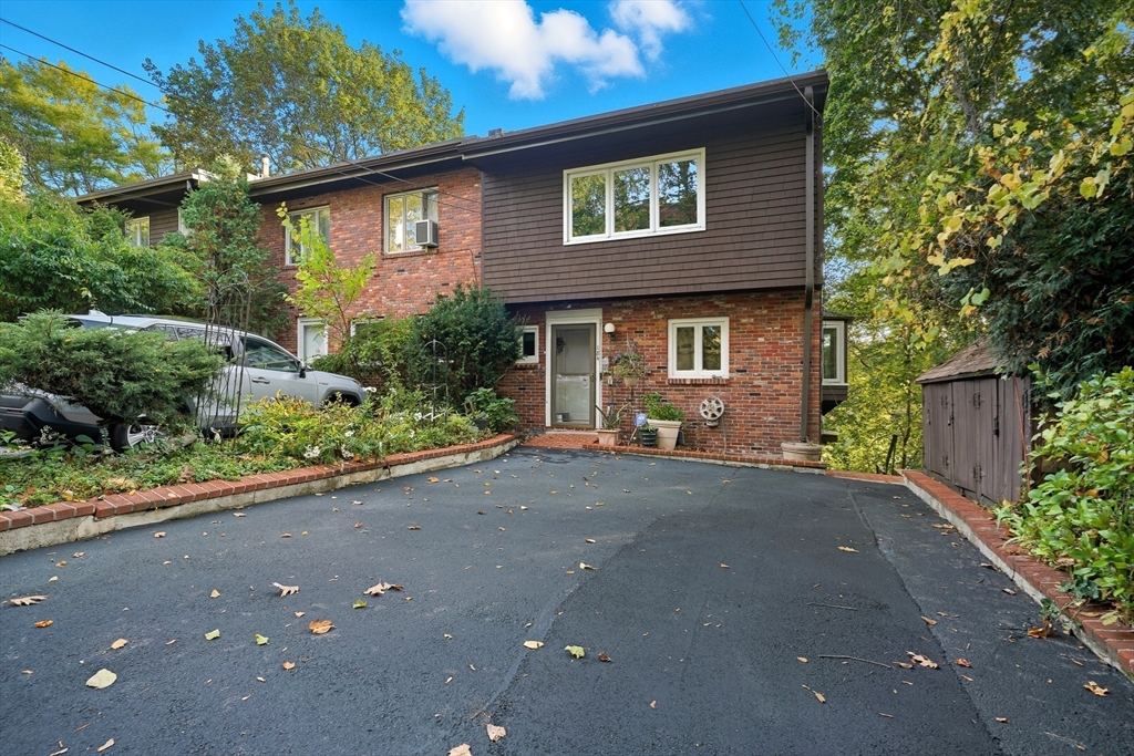 a front view of a house with a yard and a garage